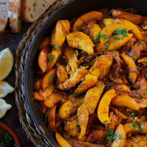 a pan of chicken with peaches cooked in Spanish sherry