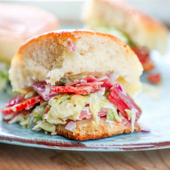 meat, cheese, and chopped lettuce salad on a Hawaiian roll. 