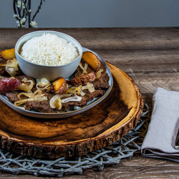 Filipino Beef Steak on a plate with a side of white rice.