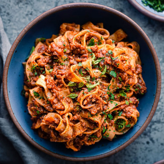 lentil bolognese in blue bowl.