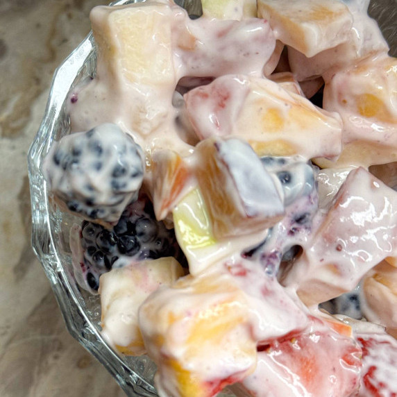 glass dish of fruit salad with yogurt dressing
