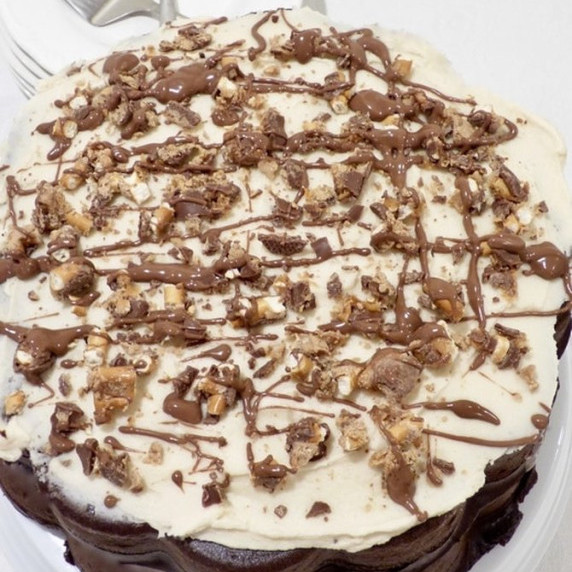 dark chocolate cake with Take Five candy bars on a white plate with white background.