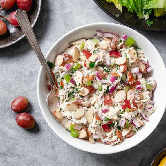 Chicken Salad with grapes and pecans on a bed of lettuce.