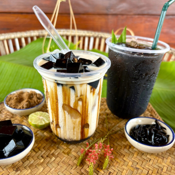 Two cups of grass jelly boba.