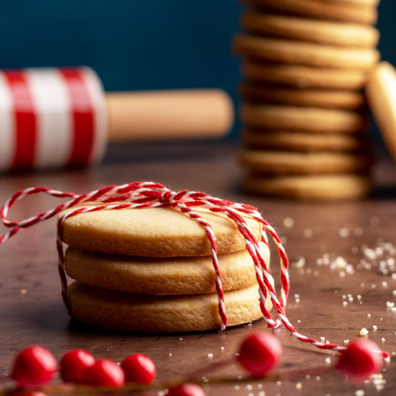 Gurabije lard cookies stacked and tied with a red and white string