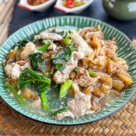 Thai lad na noodles with thick gravy and pork.