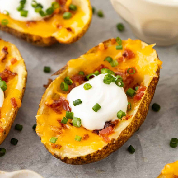 A loaded potato with sour cream and chives topping.