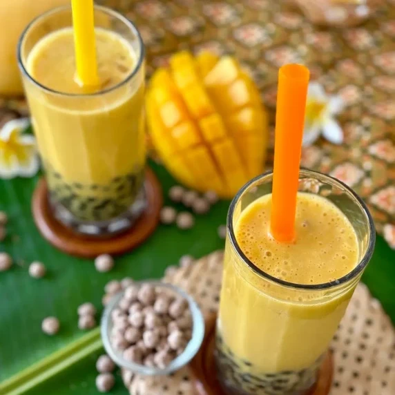 Mango bubble tea served in tall glasses.