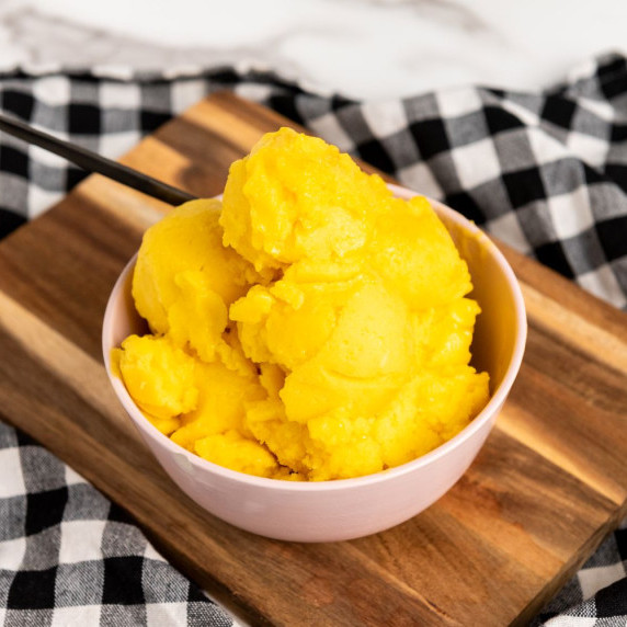A bowl with mango sorbet in a bowl on the table