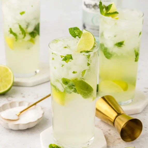 Glasses of Mint Mojitos, with lime and mint leaves.