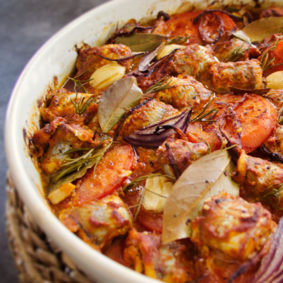 A large casserole dish sits on a counter filled with oven-baked fish casserole