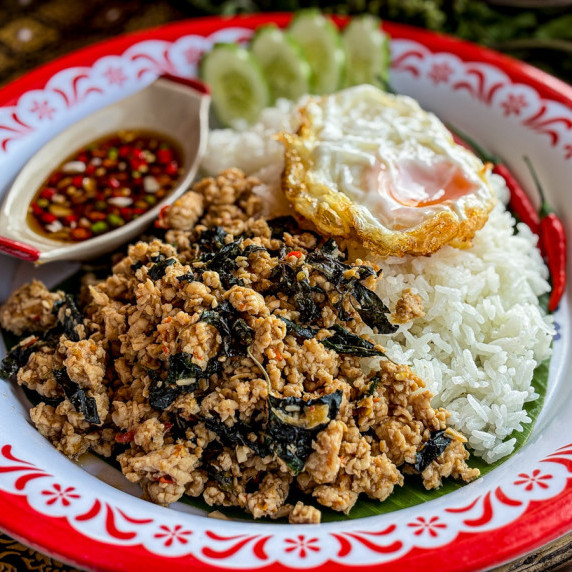 Pad kra pao chicken with jasmine rice and a fried egg.