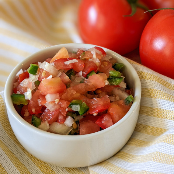 A small serving bowl of fresh pico de gallo