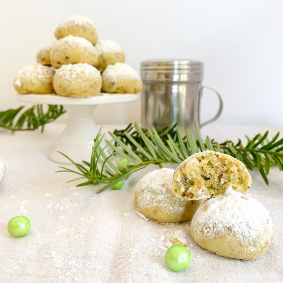 interior of pistachio snowballs in front of mountain of snowy pistachio snowballs