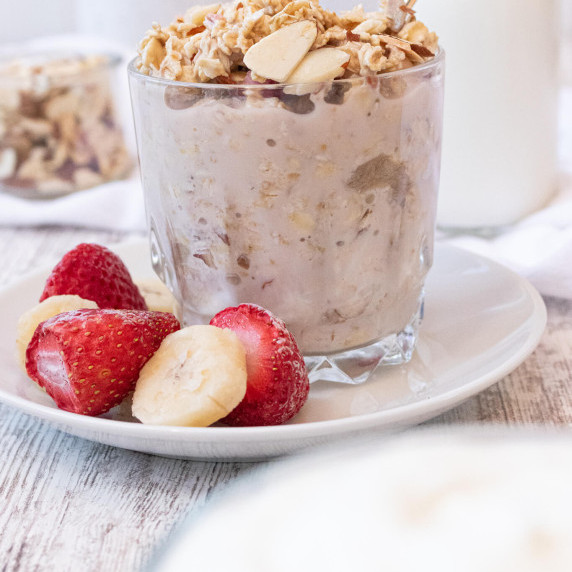 frozen fruit with overnight oats on a white plate