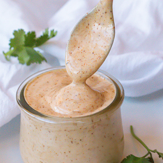 ranch in a small clear container next to cilantro