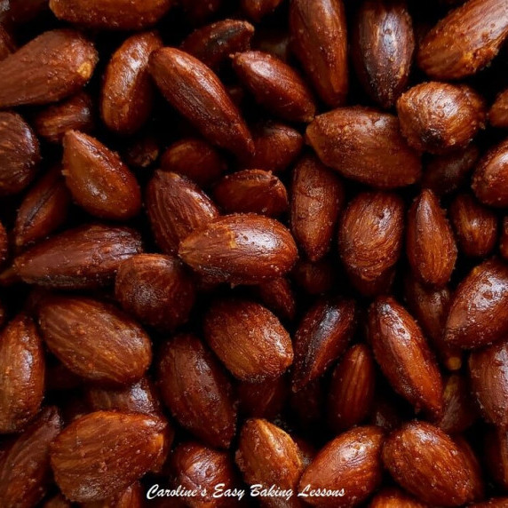 Extra extra close image of deep brown sparkly roasted smpked paprika almonds.