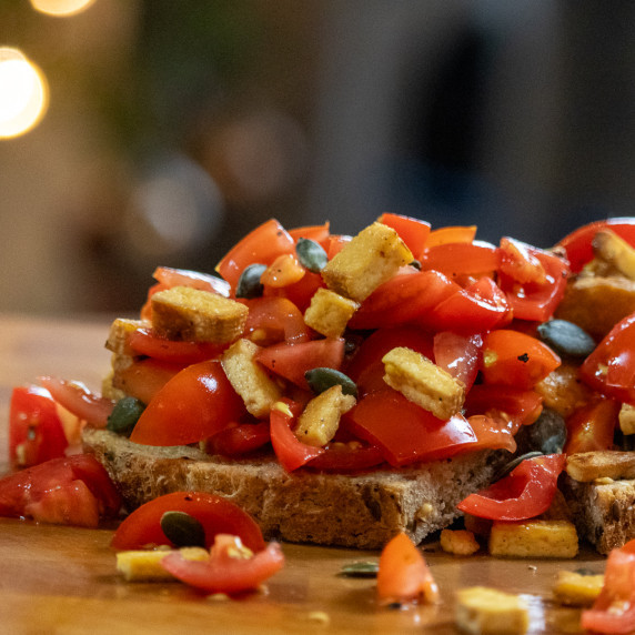 Shot of tomato, tofu and pumpkin seeds on toast.