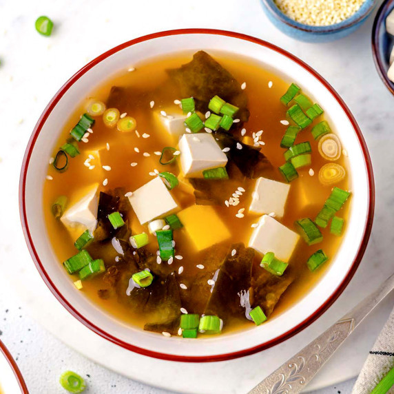 bowl with tofu and wakame miso on a white board