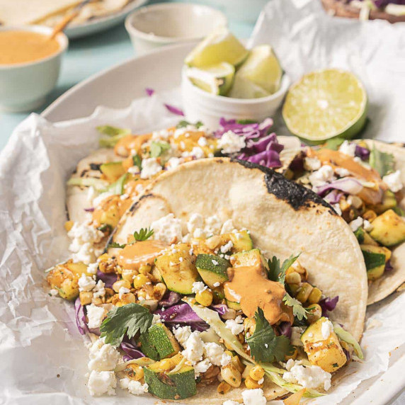 zucchini corn tacos with chipotle sauce on a plate